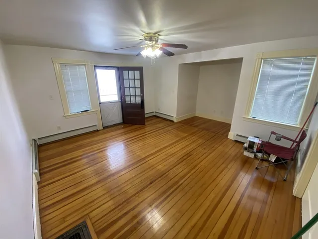 wooden floor in an empty room with a window