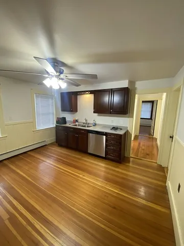 a view of a kitchen with a sink and cabinets