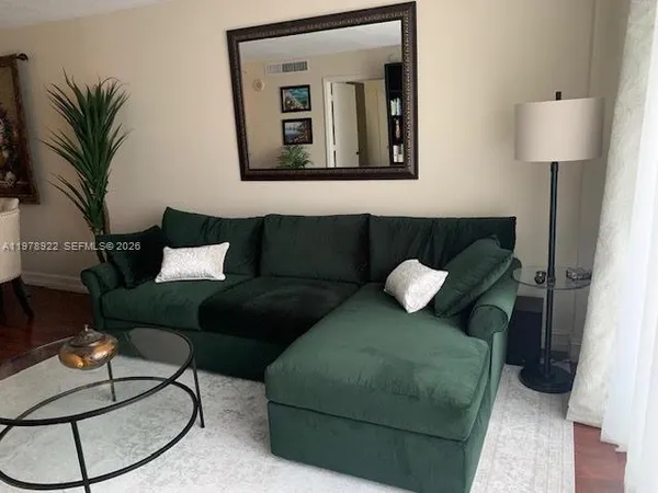 a living room with furniture and a lamp