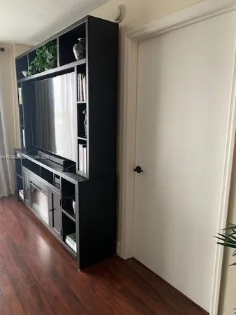 a view of a room with wooden floor