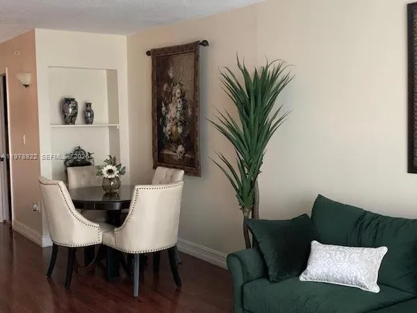 a view of a livingroom with furniture and a potted plant