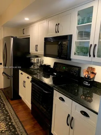 a kitchen with stainless steel appliances a stove a sink and a microwave