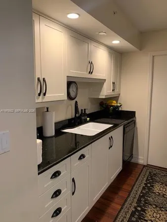 a kitchen with a sink and a stove top oven