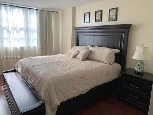 a bedroom with a bed and window