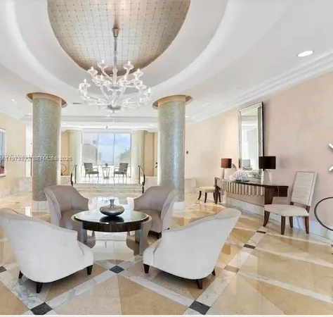 a living room with furniture and a chandelier