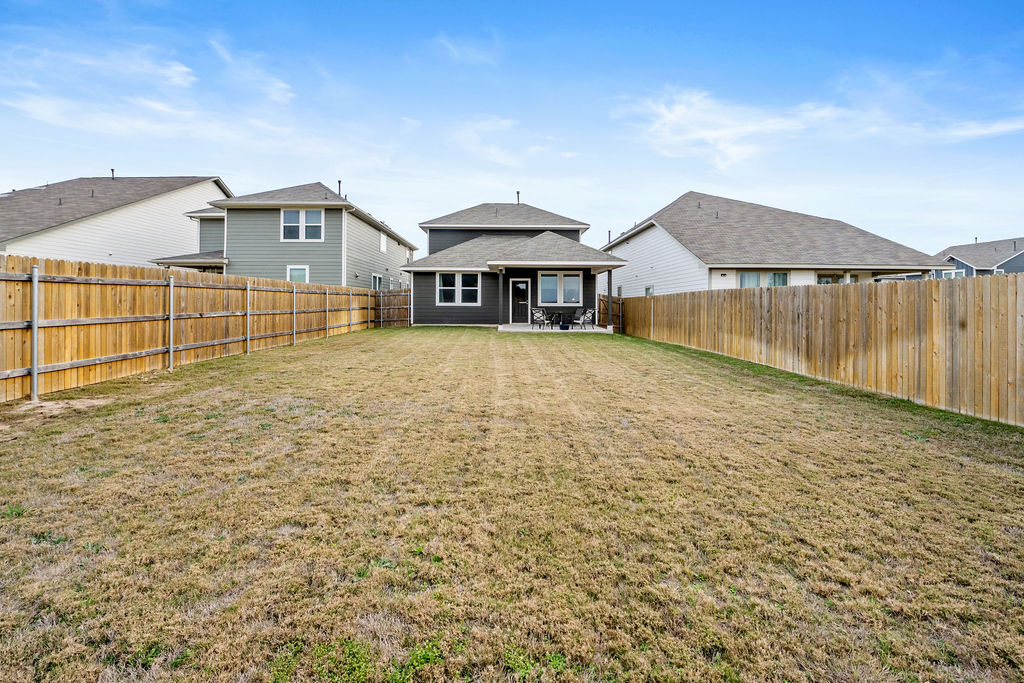 2417 Roosevelt Road Leander, TX 78641 - Photo 39 of 40 Back of property with a patio area and a fenced backyard