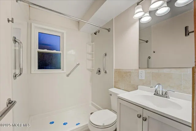 a bathroom with a toilet and a shower