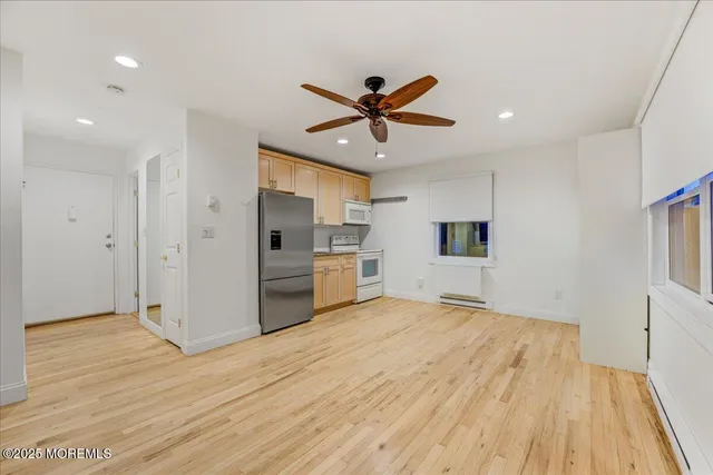 a view of kitchen with sink microwave and refrigerator