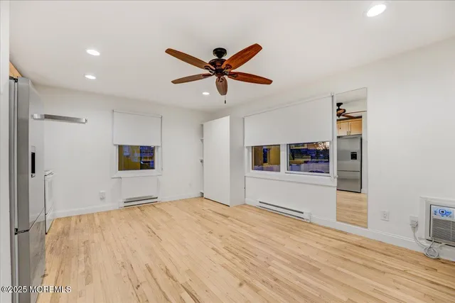 a view of a kitchen with a sink and a refrigerator
