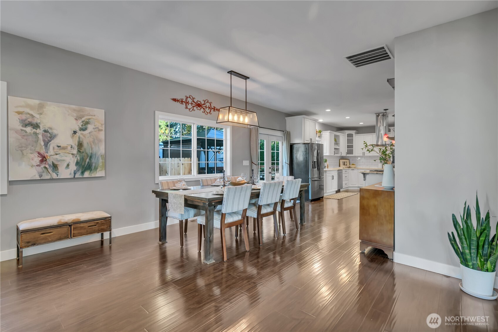 204 5th Avenue Milton, WA 98354 - Photo 6 of 37 a dining room with furniture potted plants and wooden floor