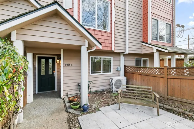 a view of a house with a window and wooden fence