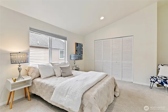 a bedroom with a bed and a table