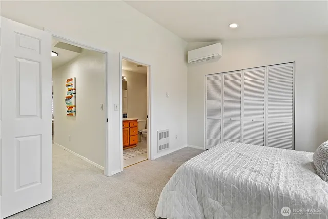 a bedroom with a large bed and a shower