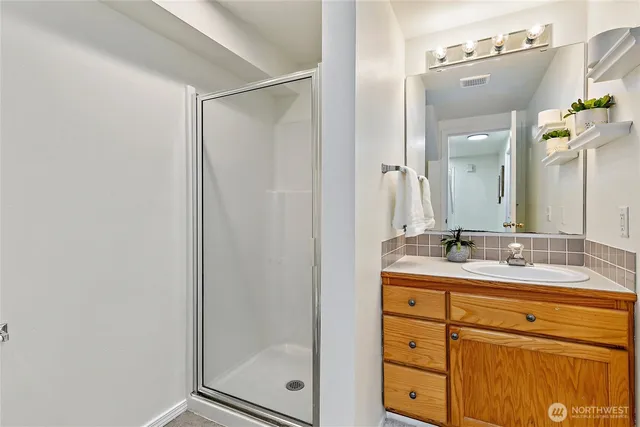 a bathroom with a granite countertop sink mirror and double