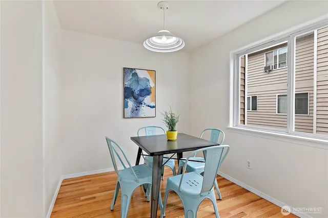 a view of a dining room with furniture and wooden floor