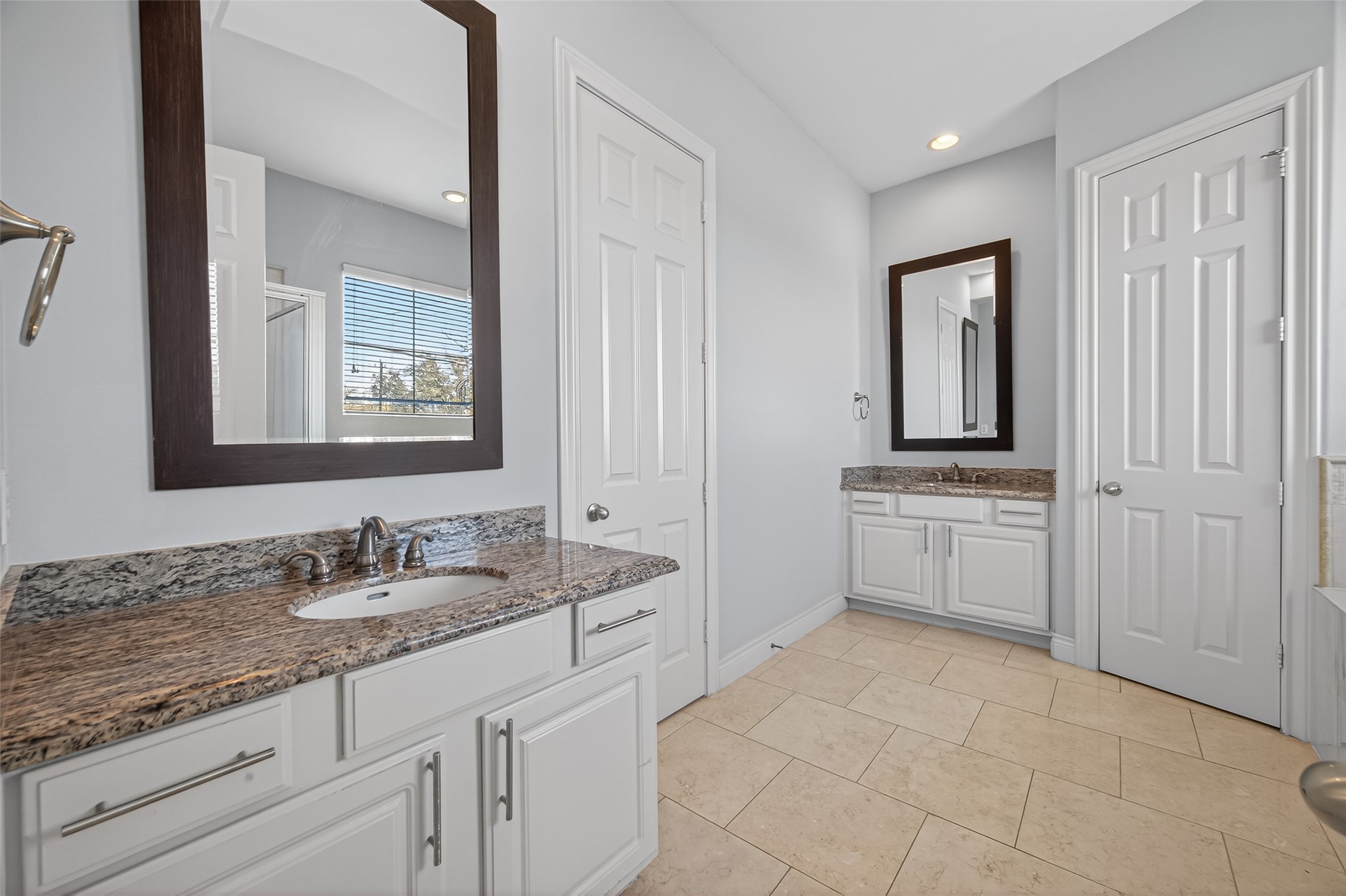 1105 Wagner Street Houston, TX 77007 - Photo 11 of 27 a spacious bathroom with a granite countertop sink a mirror and a bathtub