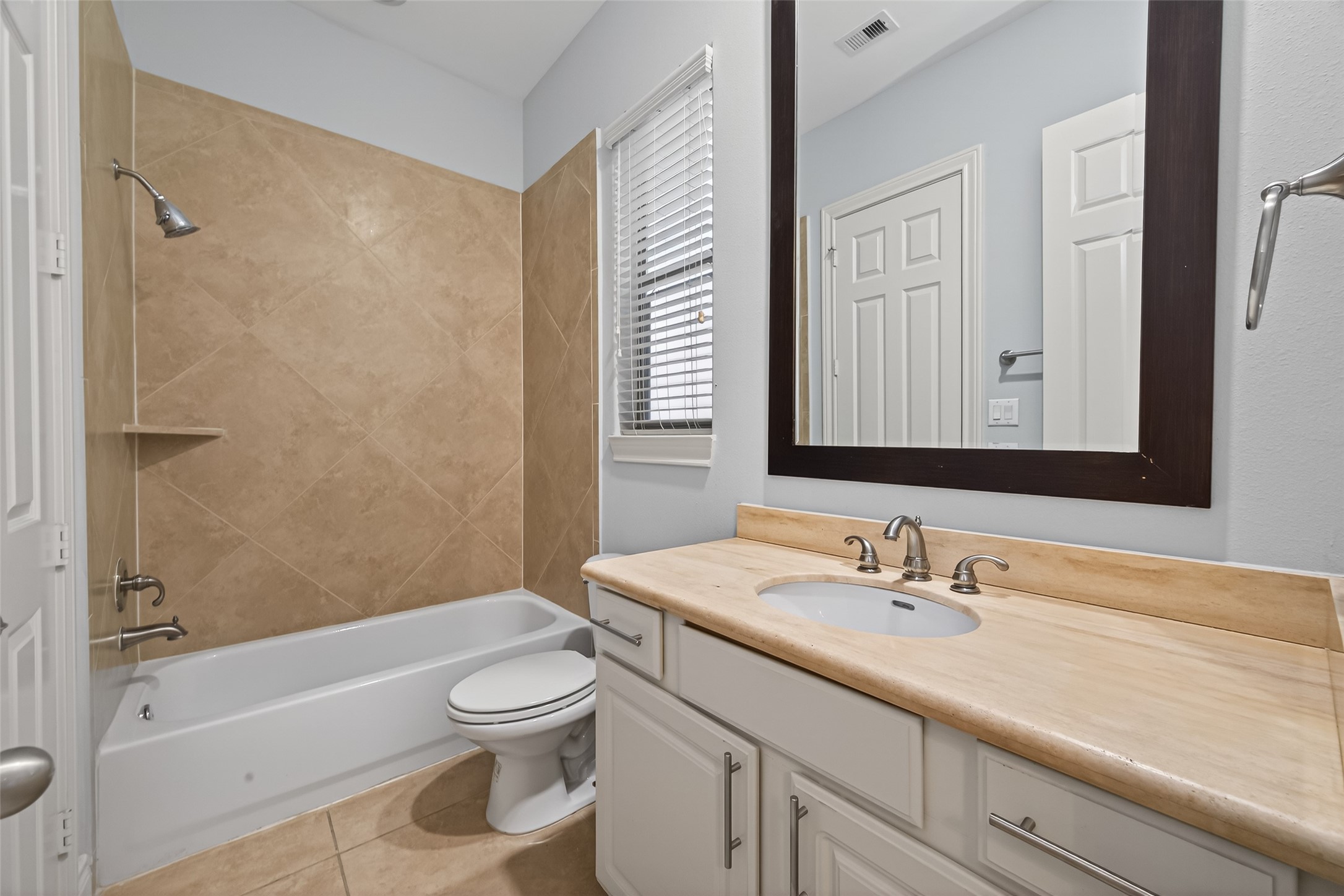 1105 Wagner Street Houston, TX 77007 - Photo 16 of 27 a bathroom with a granite countertop sink a toilet and shower