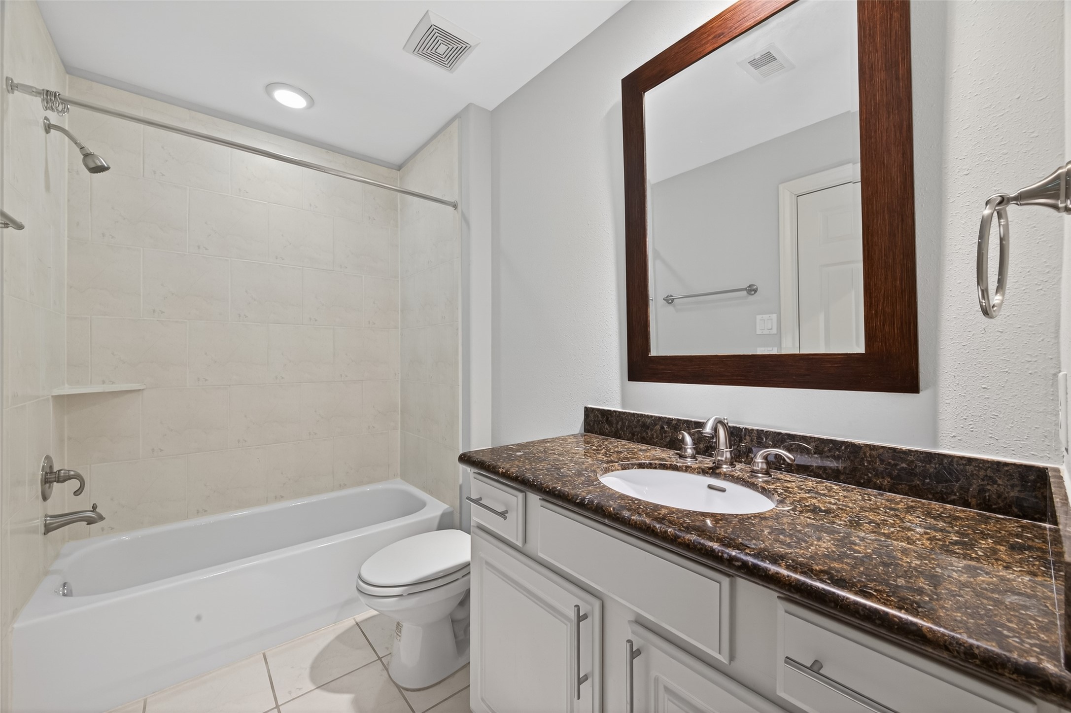 1105 Wagner Street Houston, TX 77007 - Photo 23 of 27 a bathroom with a granite countertop sink a toilet and bathtub