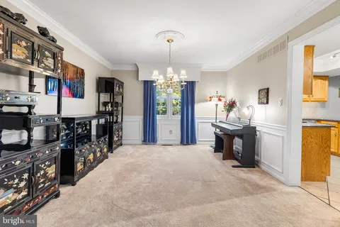 a living room with fireplace furniture and a chandelier