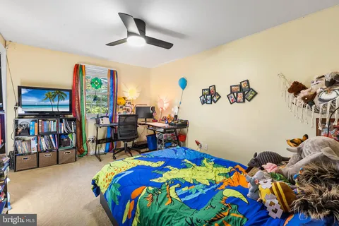 a bedroom with a bed and a book shelf