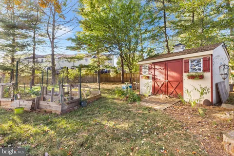 a aerial view of a house with a yard and potted plants