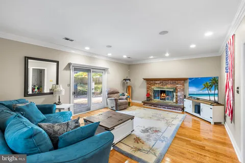 a living room with fireplace furniture and a flat screen tv