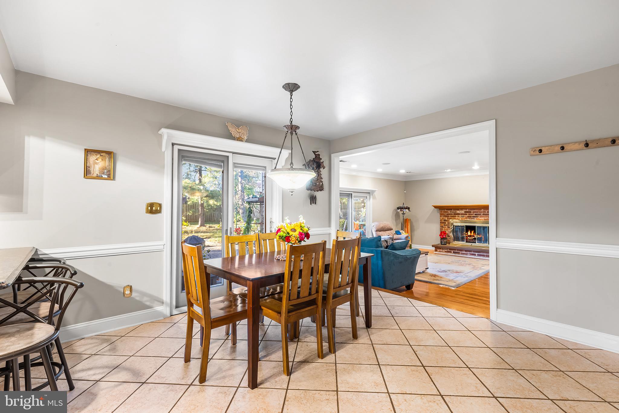 511 Faith Drive Norristown, PA 19403 - Photo 9 of 39 a dining room with furniture a chandelier and fireplace