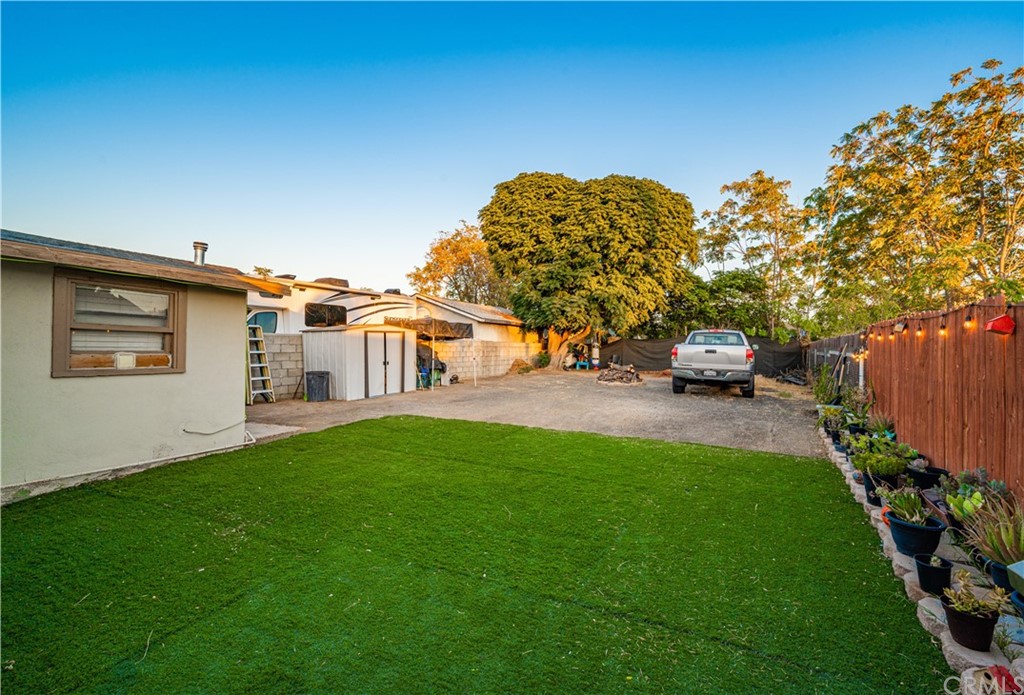 7434 Evans Street Riverside, CA 92504 - Photo 12 of 16 a view of a back yard of the house with a large tree