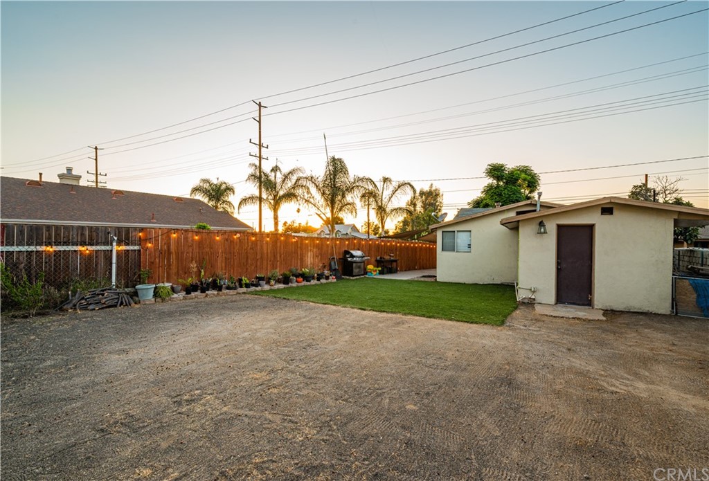 7434 Evans Street Riverside, CA 92504 - Photo 15 of 16 a view of a house with a backyard and a garage
