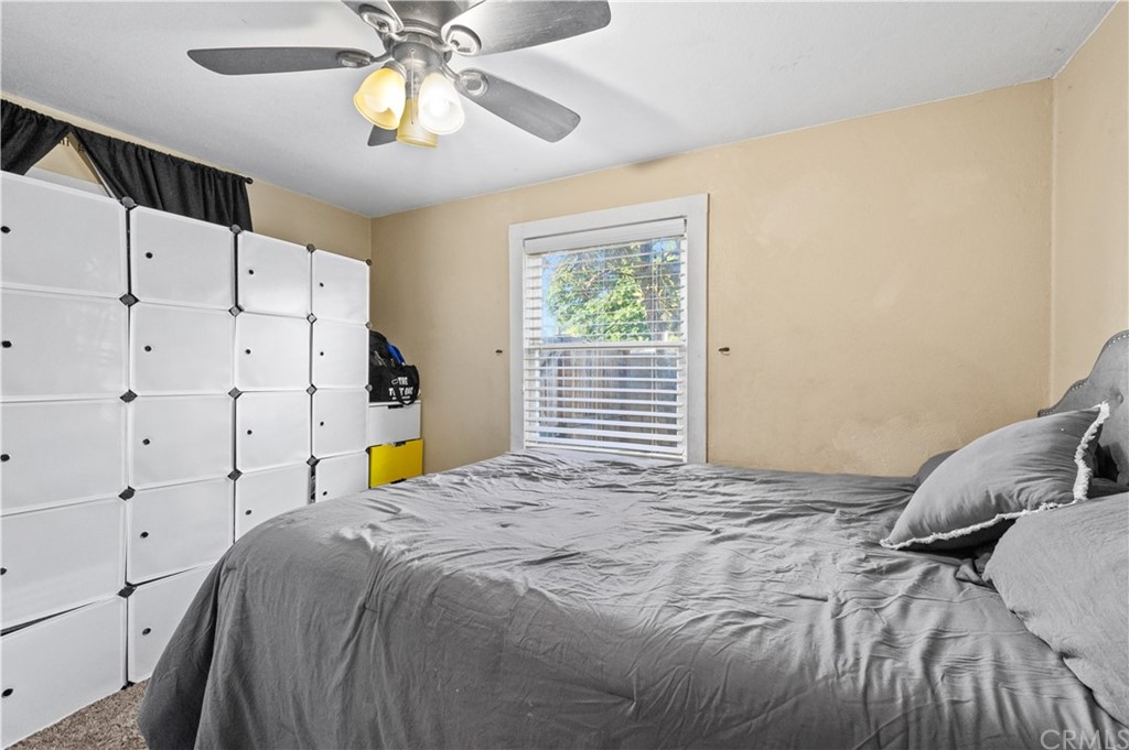 7434 Evans Street Riverside, CA 92504 - Photo 4 of 16 a bed room with a bed and a chandelier