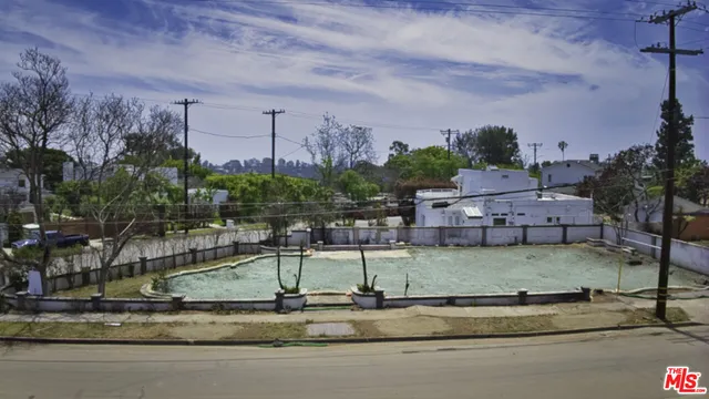 a backyard of a house with lots of green space and fountain