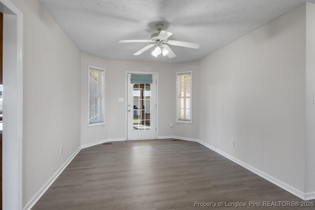 151 Ballard Drive Raeford, NC 28376 - Photo 16 of 34 a view of an empty room with a window and wooden floor