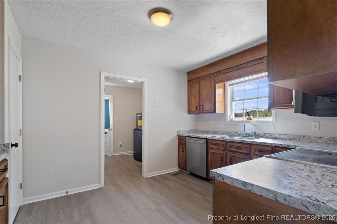 151 Ballard Drive Raeford, NC 28376 - Photo 19 of 34 a kitchen with stainless steel appliances granite countertop a sink and a stove