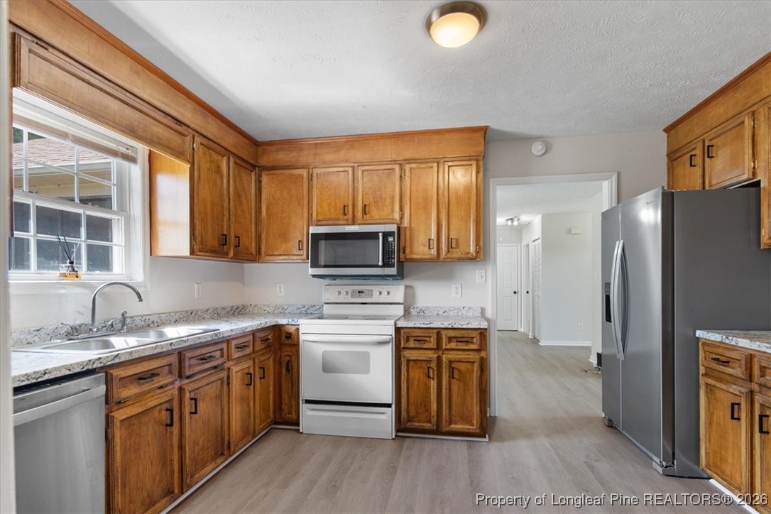 151 Ballard Drive Raeford, NC 28376 - Photo 20 of 34 a kitchen with granite countertop a sink stainless steel appliances and cabinets