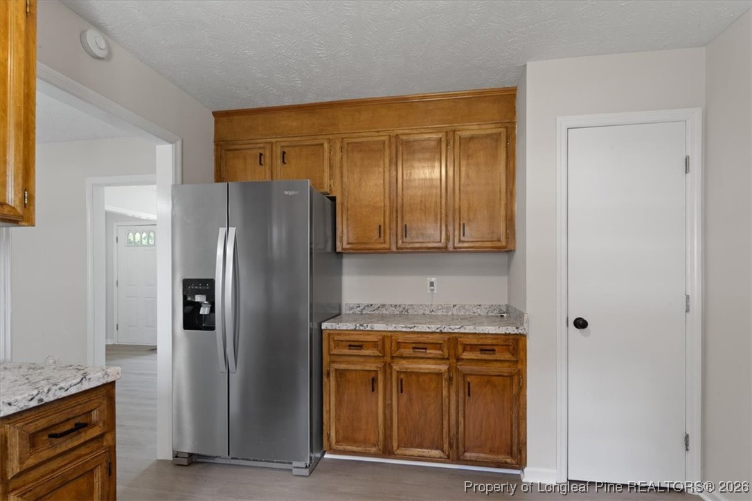 151 Ballard Drive Raeford, NC 28376 - Photo 23 of 34 a bathroom with a granite countertop sink and a refrigerator