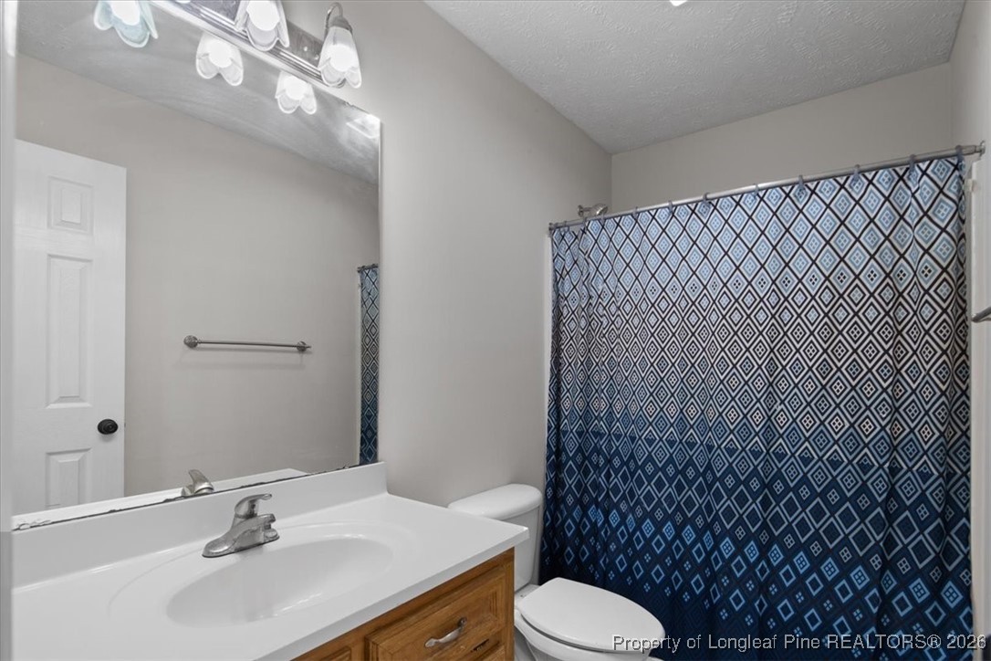 151 Ballard Drive Raeford, NC 28376 - Photo 24 of 34 a bathroom with a sink toilet and shower