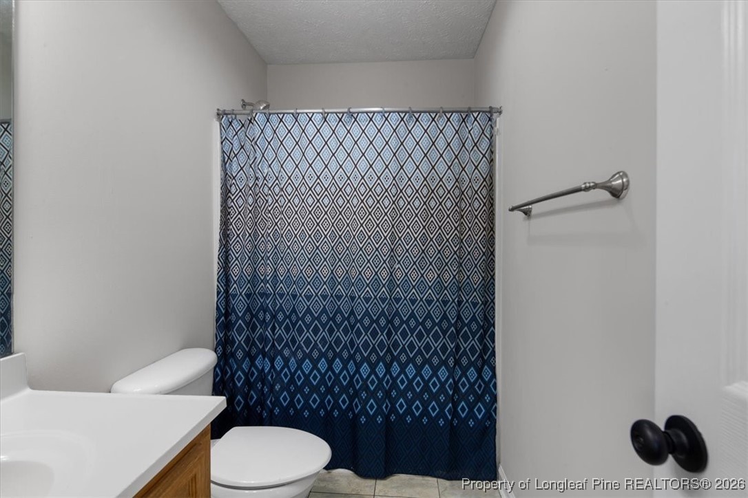 151 Ballard Drive Raeford, NC 28376 - Photo 25 of 34 a bathroom with a toilet and a shower curtain