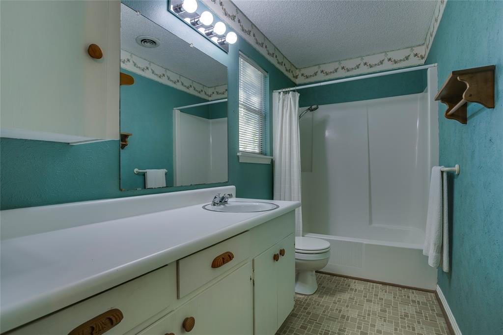 1439 Jr Drive Dallas, TX 75208 - Photo 25 of 39 a bathroom with a sink a toilet and shower
