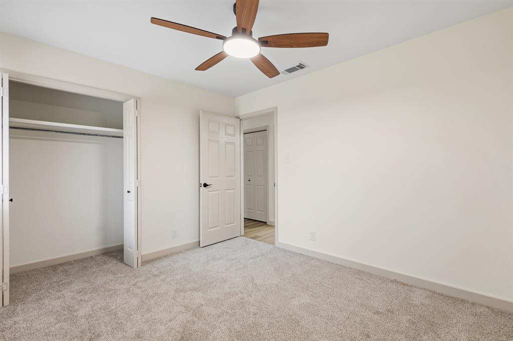 1510 Finley Road Irving, TX 75062 - Photo 11 of 17 an empty room with chandelier fan
