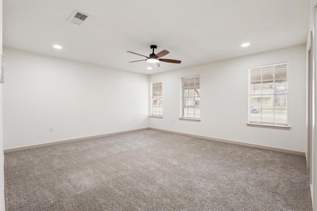 1510 Finley Road Irving, TX 75062 - Photo 15 of 17 an empty room with windows and ceiling fan
