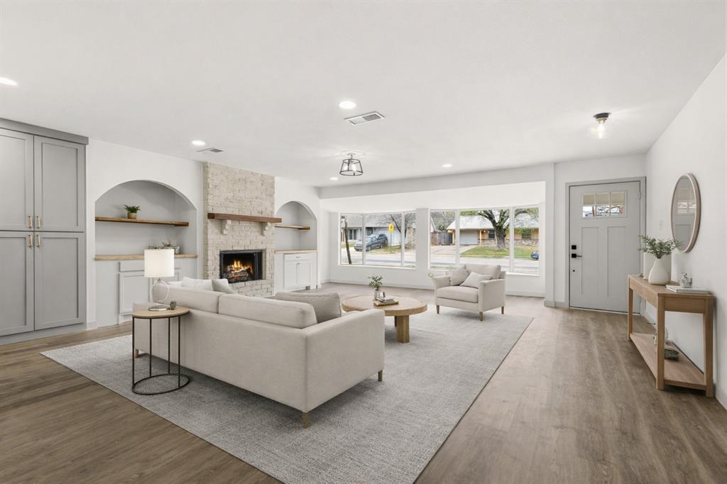 1510 Finley Road Irving, TX 75062 - Photo 2 of 17 a living room with fireplace furniture and a wooden floor