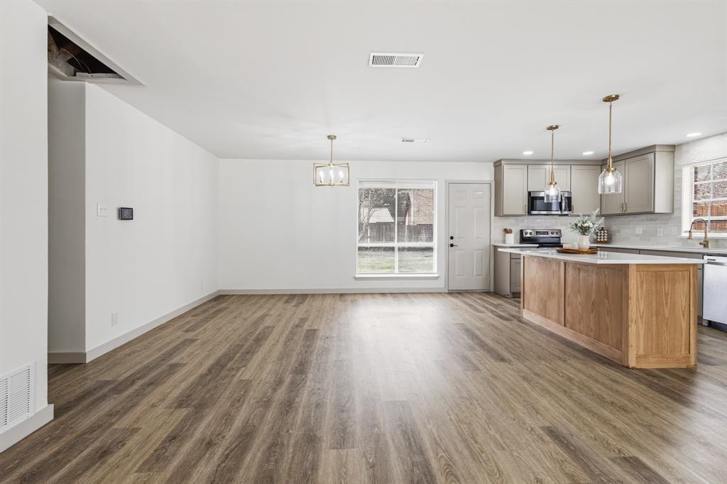 1510 Finley Road Irving, TX 75062 - Photo 8 of 17 a view of kitchen with wooden floor and window