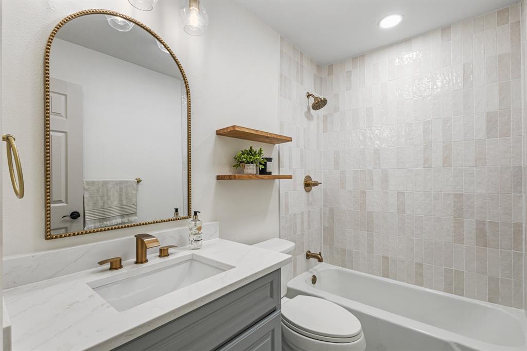 1510 Finley Road Irving, TX 75062 - Photo 9 of 17 a bathroom with a sink toilet and shower