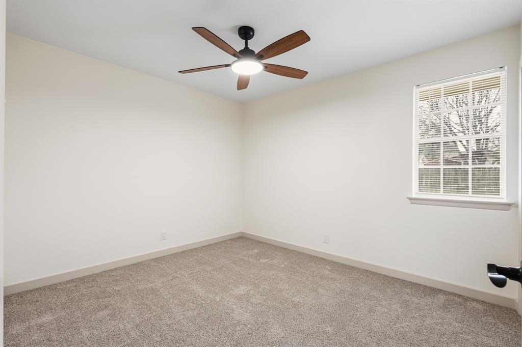 1510 Finley Road Irving, TX 75062 - Photo 10 of 17 an empty room with windows and ceiling fan