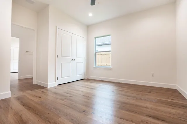 a view of an empty room with wooden floor