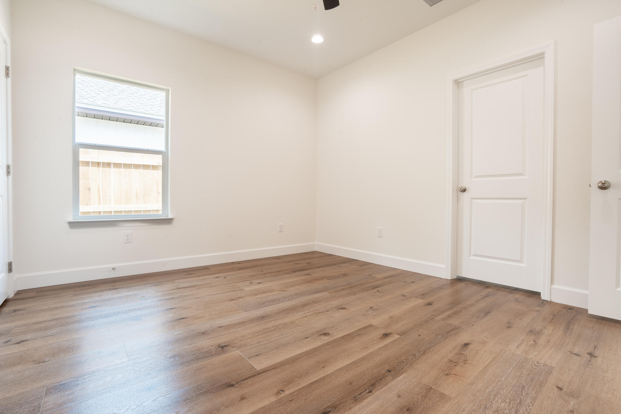 21 B 5th Avenue Shalimar, FL 32579 - Photo 12 of 21 an empty room with wooden floor and windows