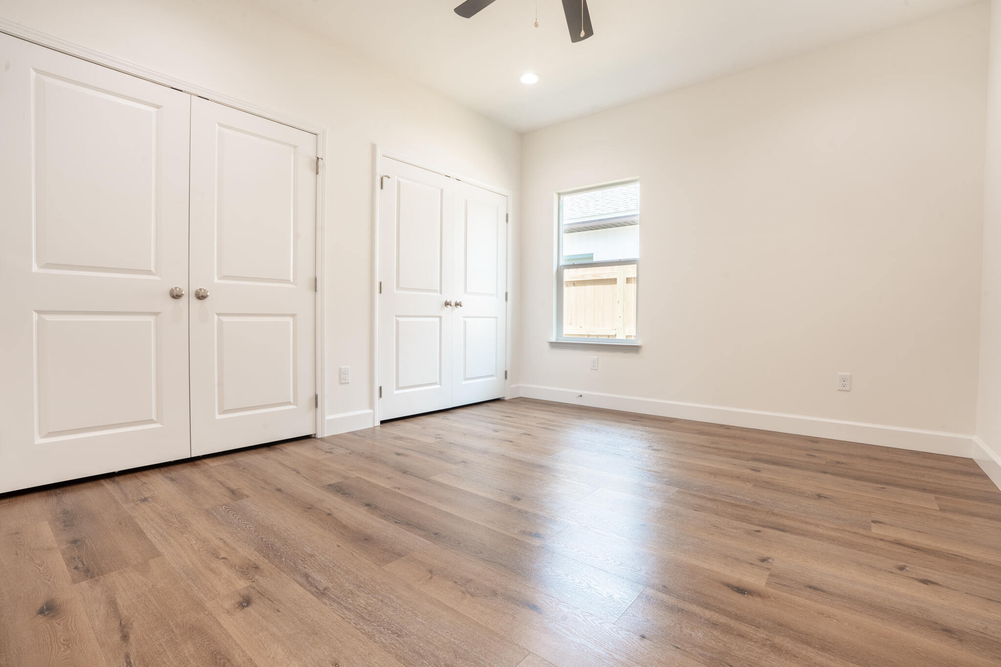 21 B 5th Avenue Shalimar, FL 32579 - Photo 18 of 21 a view of an empty room with wooden floor and a window