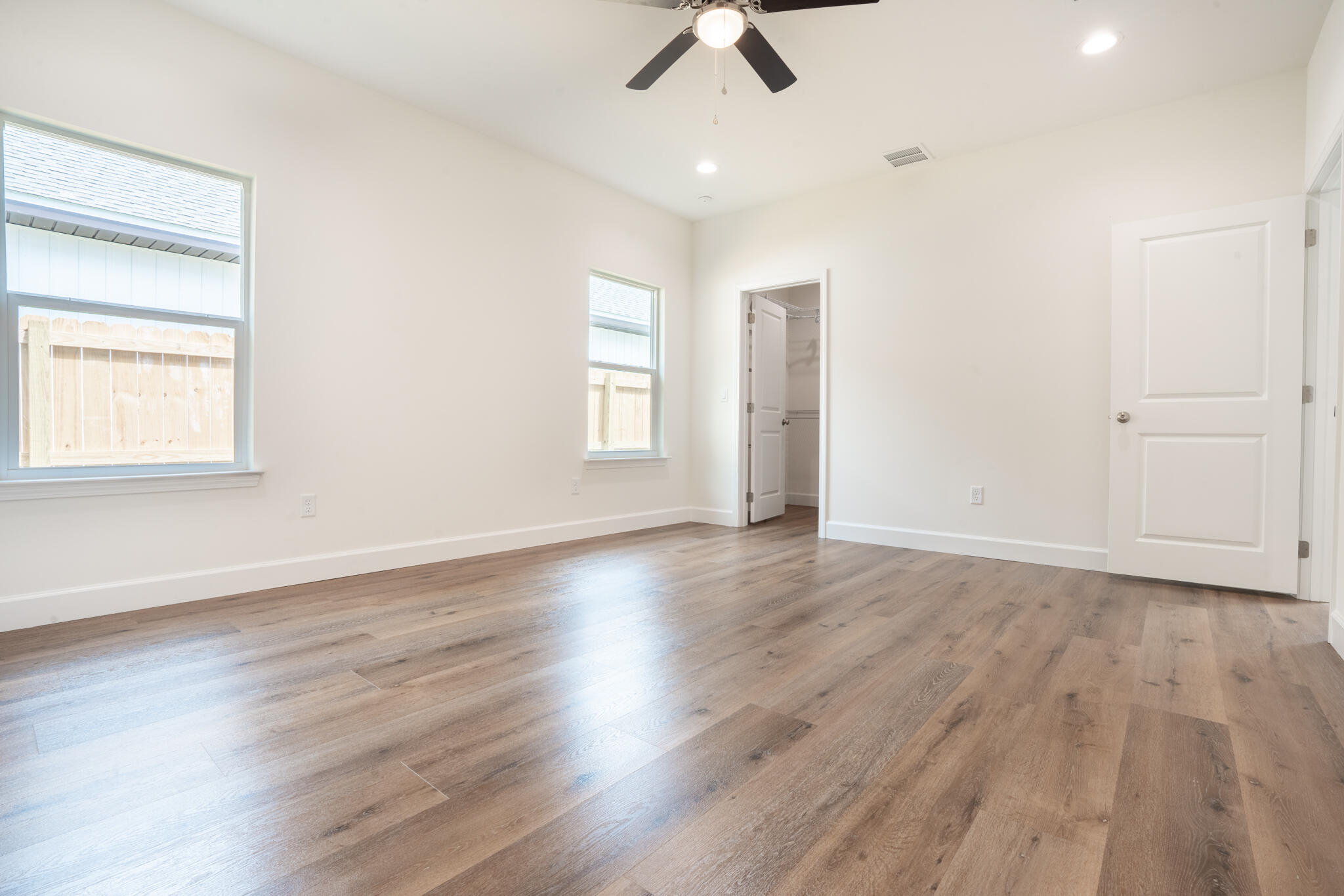 21 B 5th Avenue Shalimar, FL 32579 - Photo 19 of 21 an empty room with wooden floor fan and windows