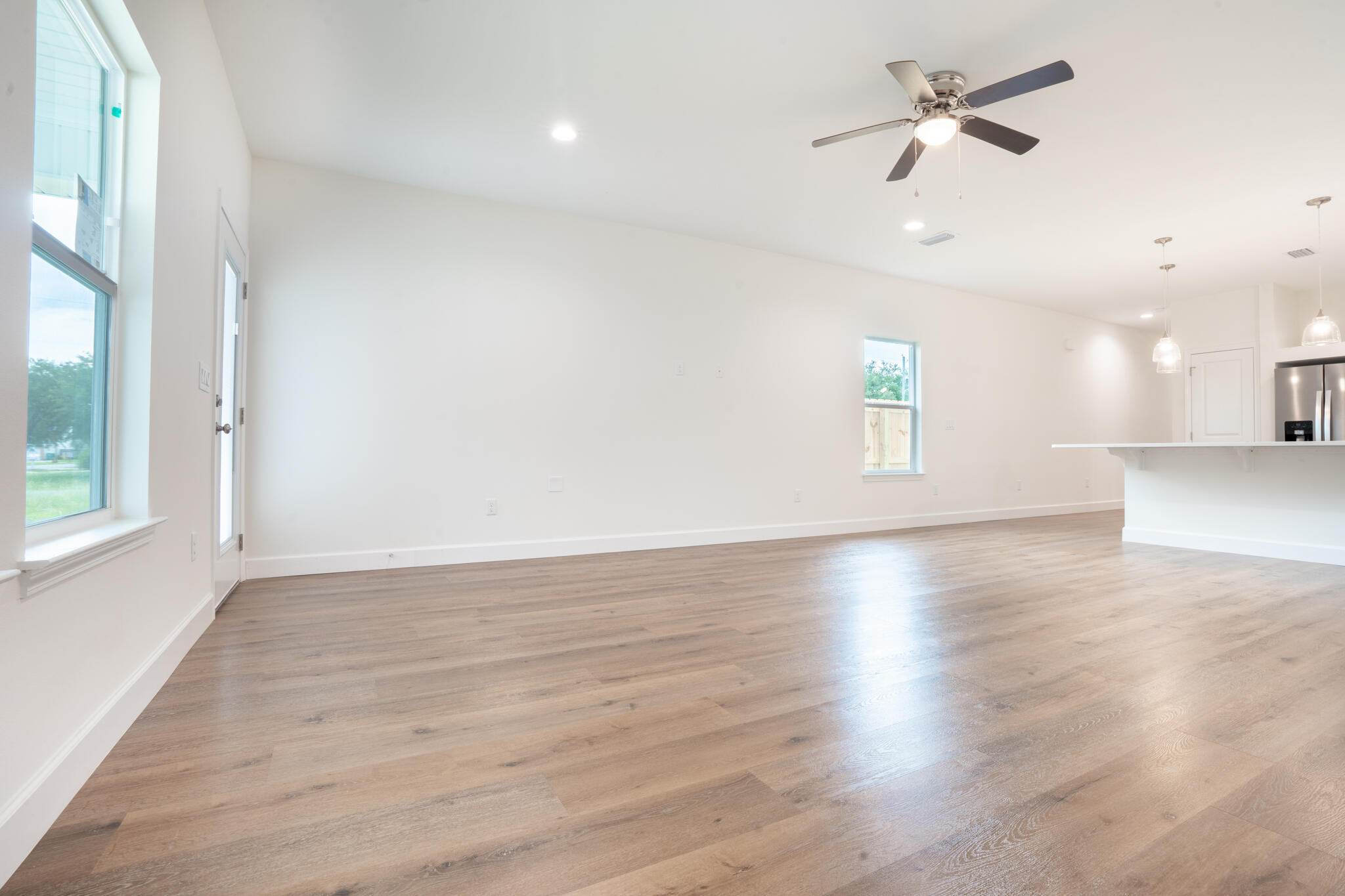 21 B 5th Avenue Shalimar, FL 32579 - Photo 6 of 21 an empty room with wooden floor fan and windows