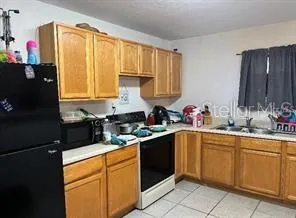 a kitchen with a sink cabinets and window